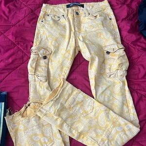 Stacked Valabasas skinny yellow paisley jeans